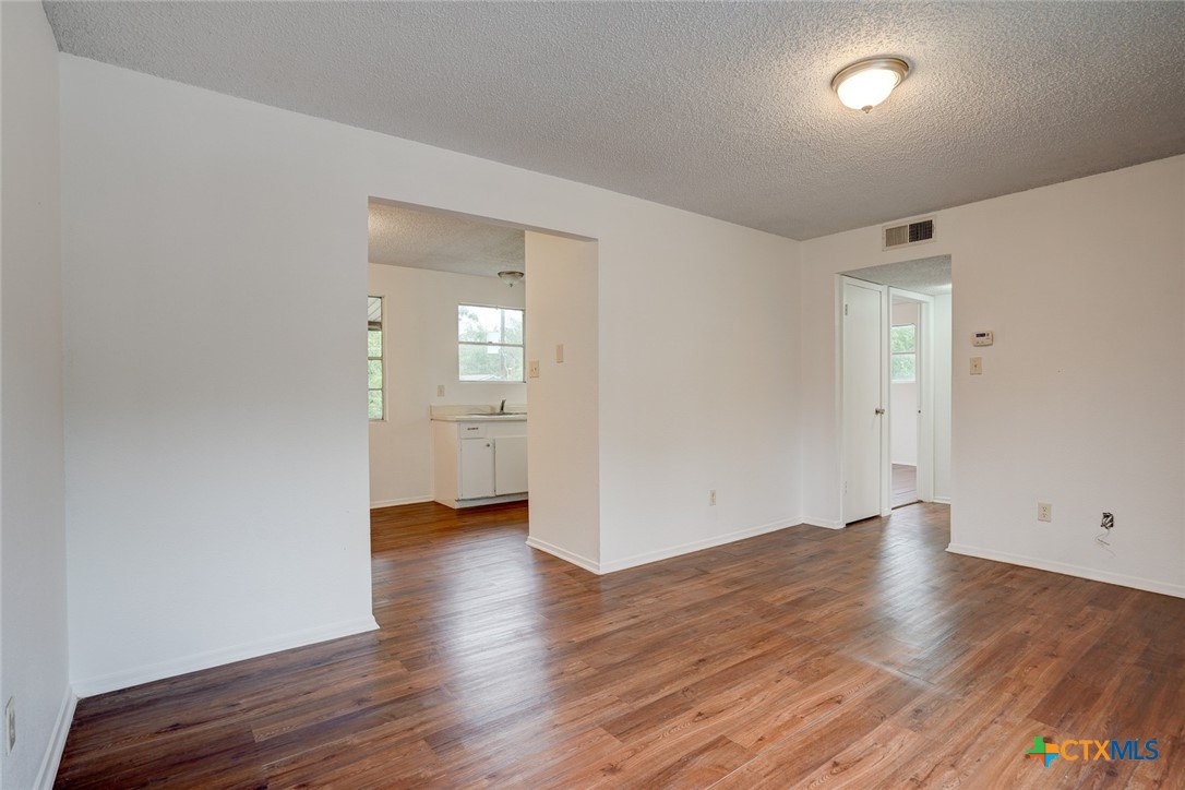 726 Old Martindale Road San Marcos, TX 78666 - Photo 4 of 18 wooden floor in an empty room with a window
