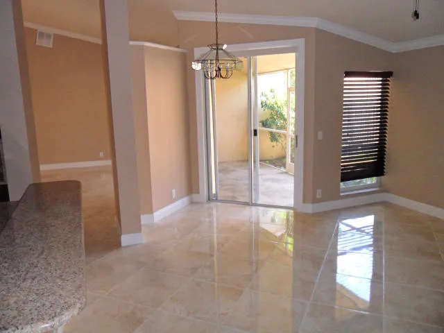 a view of an empty room with a fireplace and a window