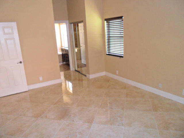 10123 Caoba Street Palm Beach Gardens, FL 33410 - Photo 6 of 16 an empty room with windows