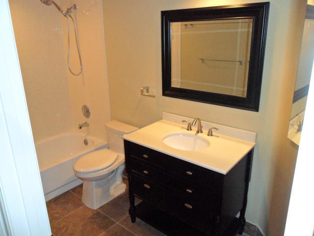 10123 Caoba Street Palm Beach Gardens, FL 33410 - Photo 9 of 16 a bathroom with a sink vanity mirror and toilet