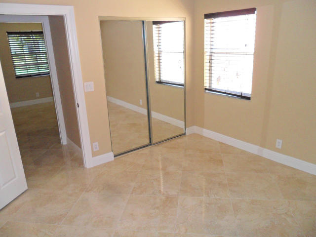 10123 Caoba Street Palm Beach Gardens, FL 33410 - Photo 10 of 16 an empty room with windows
