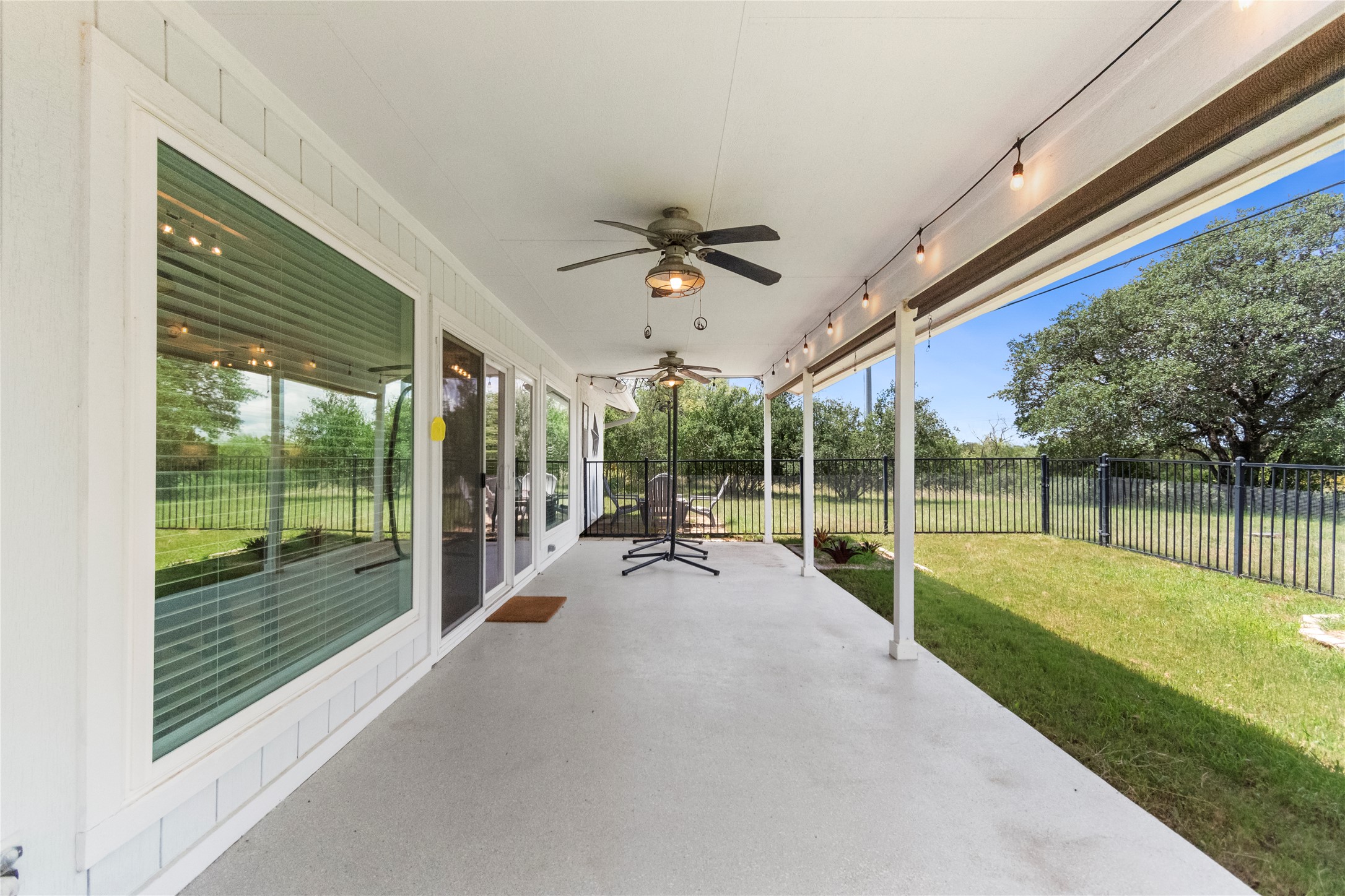 210 Teeoff, Unit B Horseshoe Bay, TX 78657 - Photo 29 of 38 A spacious, covered concrete patio overlooks a fenced green space.
