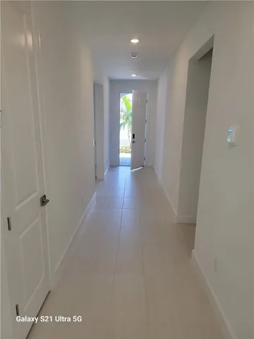 a view of hallway with wooden floor