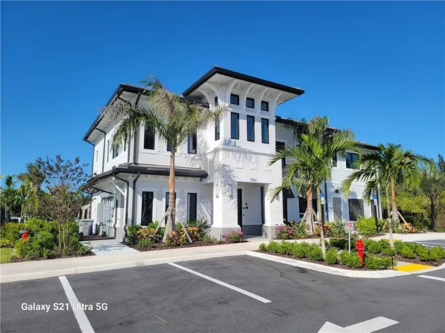 a front view of a house with a garden and plants