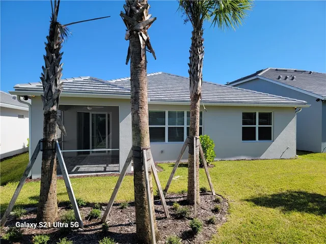 a view of house with swimming pool and porch