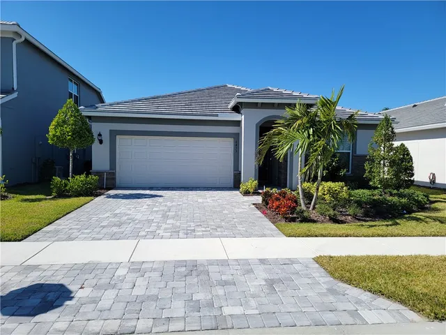 a view of a house with a small yard and plants