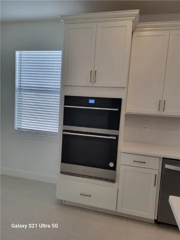 a stove top oven sitting inside of a kitchen