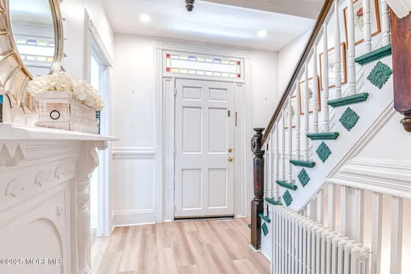 a view of an entryway with wooden floor
