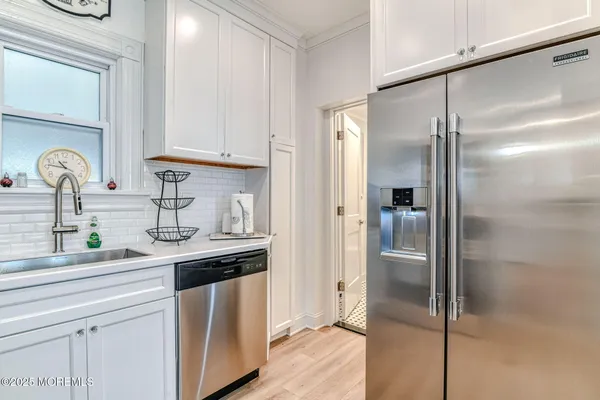 a kitchen with stainless steel appliances granite countertop a refrigerator and a sink