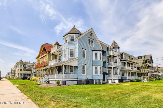 a view of a big building with a big yard and large trees