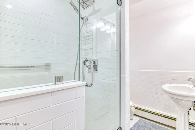 a bathroom with a shower and a sink