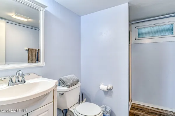 a bathroom with a sink toilet and a mirror