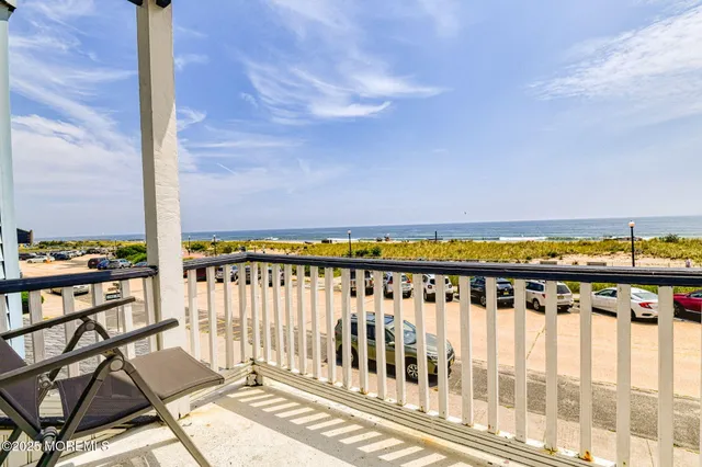 a view of a balcony with wooden chairs