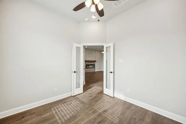 an empty room with a ceiling fan and a window