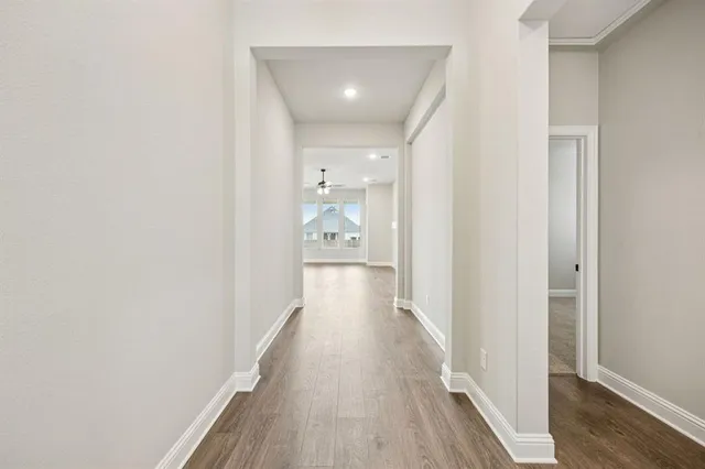 a view of a hallway with wooden floor