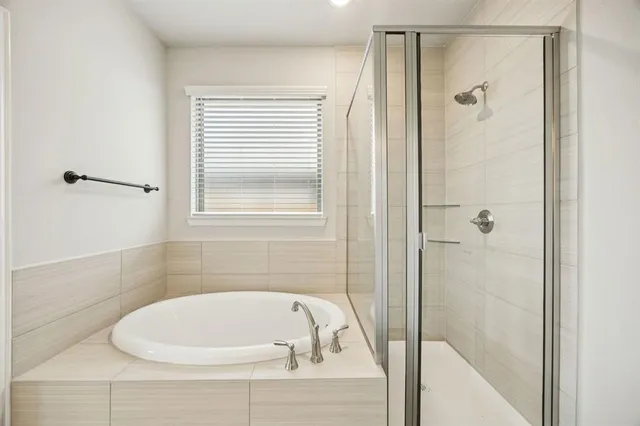 a white bath tub sitting next to a shower