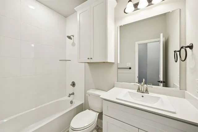 a bathroom with a sink a toilet and bathtub