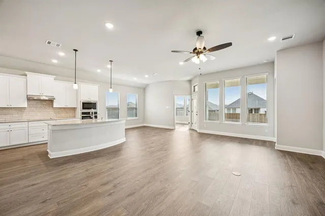 a view of kitchen with refrigerator and window