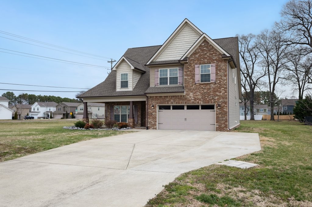 1752 John Lee Lane Murfreesboro, TN 37128 - Photo 2 of 39 a front view of a house with a yard and garage