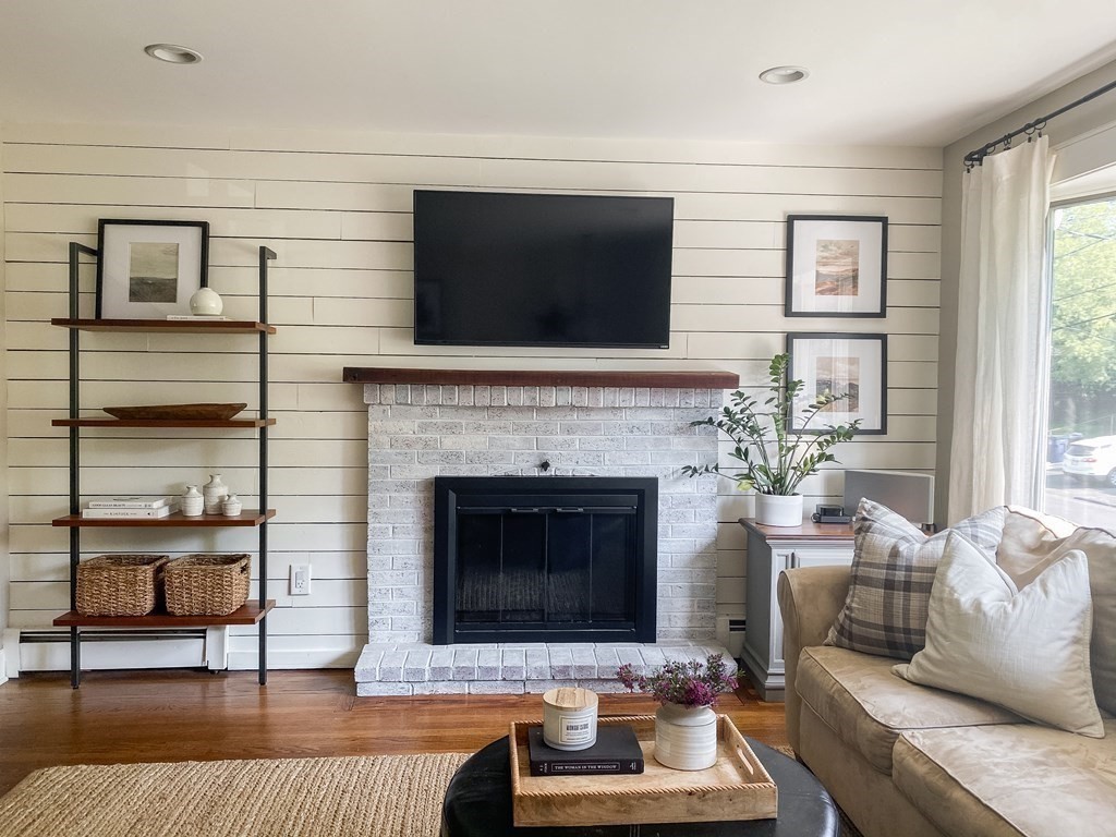 20 Crescent Drive Salem, MA 01970 - Photo 7 of 21 a living room with furniture a flat screen tv and a fireplace