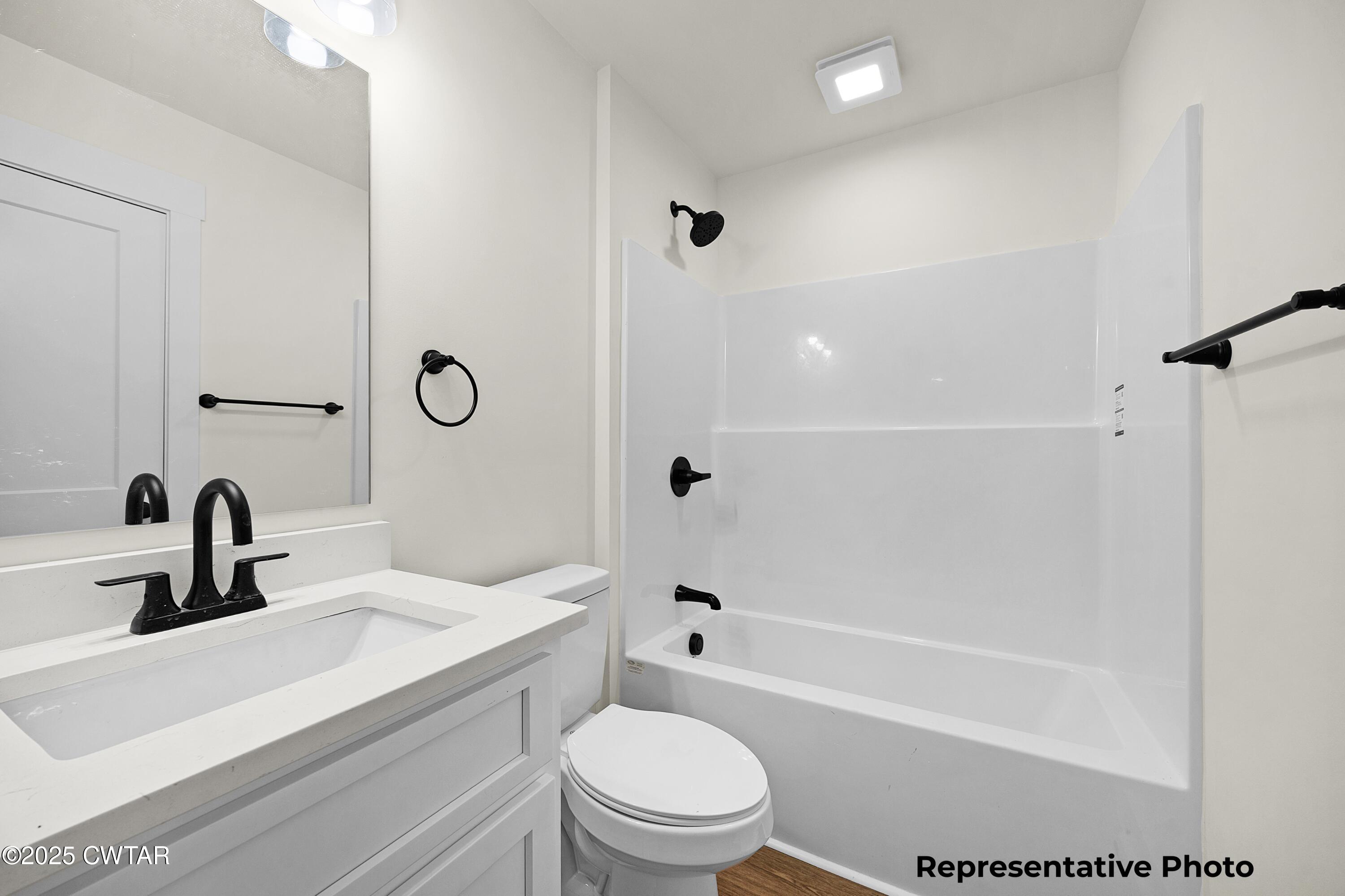 118 Roland Avenue Jackson, TN 38301 - Photo 12 of 24 a bathroom with a sink a toilet and shower