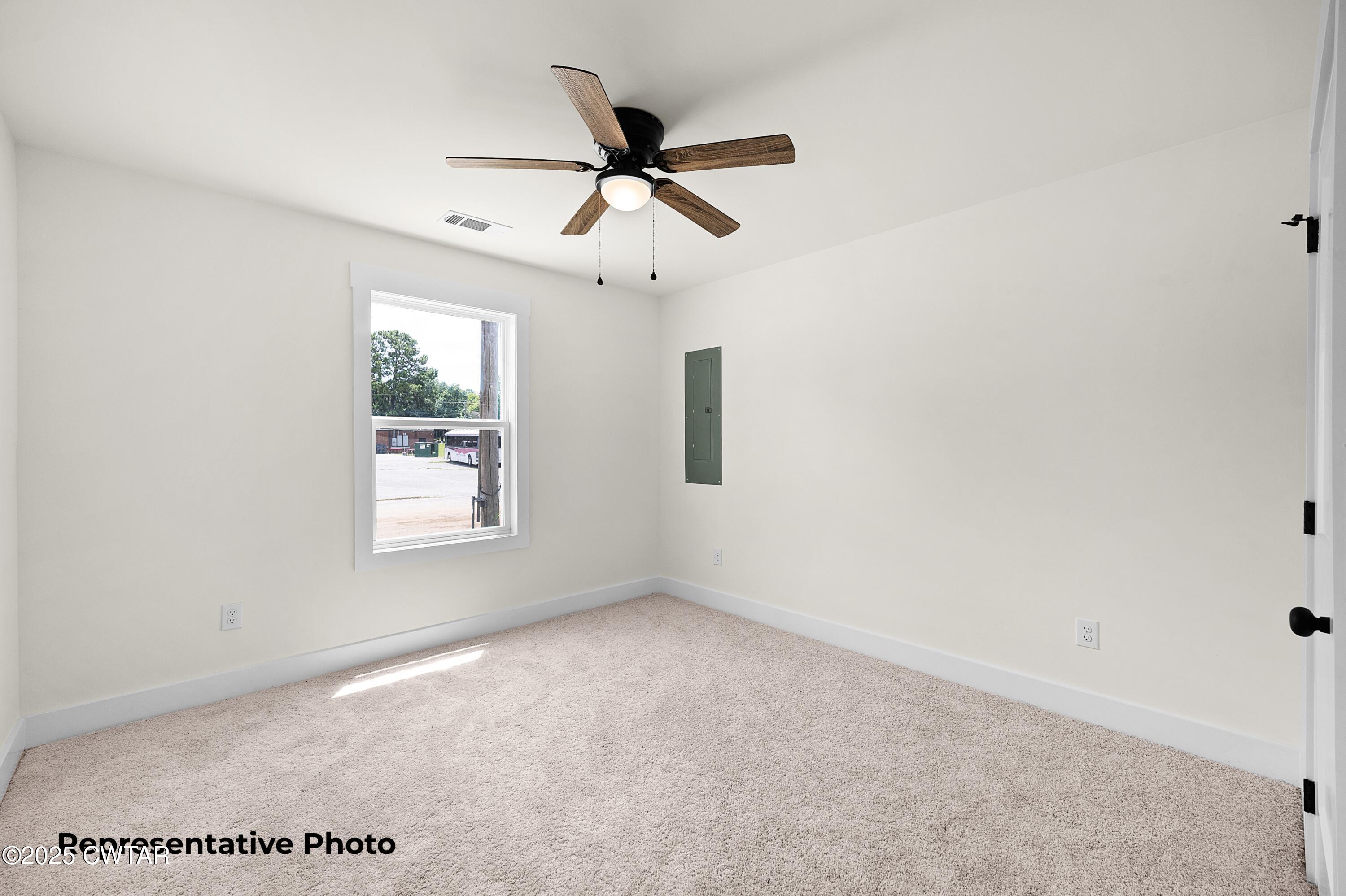 118 Roland Avenue Jackson, TN 38301 - Photo 13 of 24 an empty room with ceiling fan and window