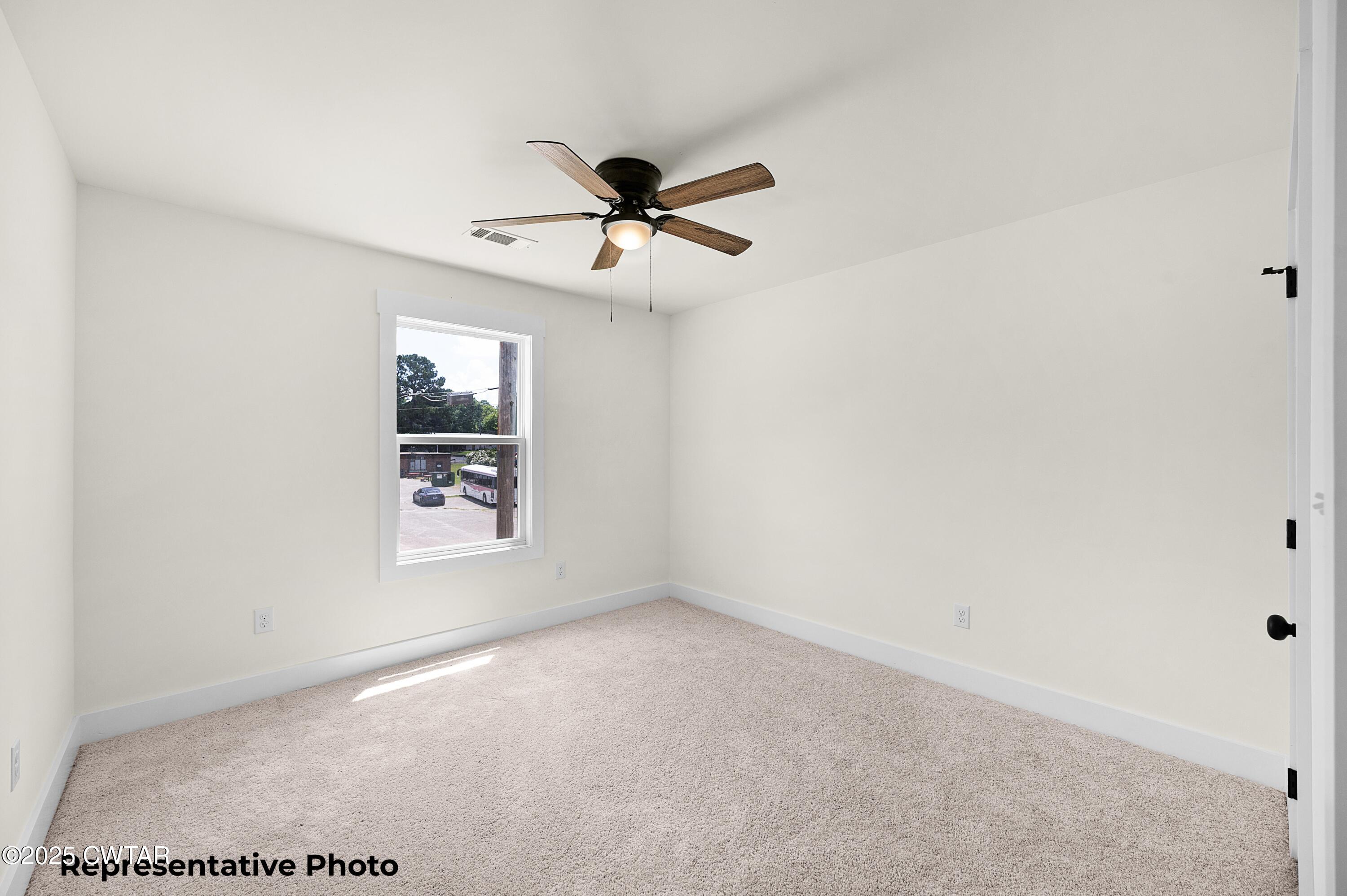 118 Roland Avenue Jackson, TN 38301 - Photo 20 of 24 a view of a big room with carpet