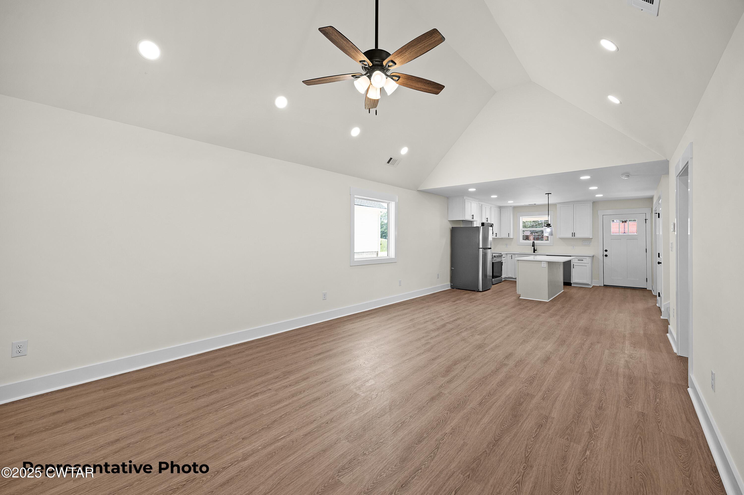 118 Roland Avenue Jackson, TN 38301 - Photo 7 of 24 a view of an empty room with a window and wooden floor