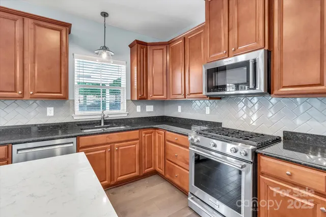a view of kitchen with sink and wooden floor