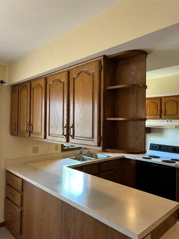 a kitchen with a sink and a refrigerator