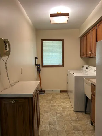 a room with a sink cabinets and utility room