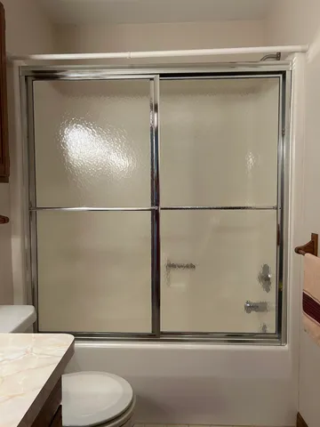 a bathroom with a shower and a toilet