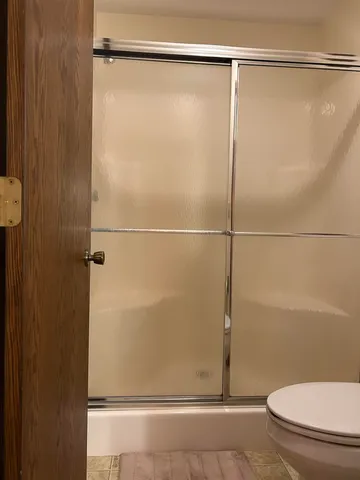 a bathroom with a shower and a toilet