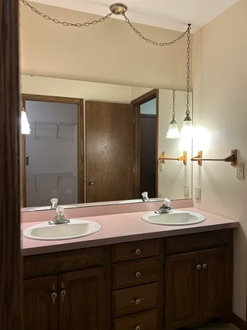 a bathroom with a double vanity sink and a mirror