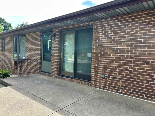 a view of a brick house with a black gate
