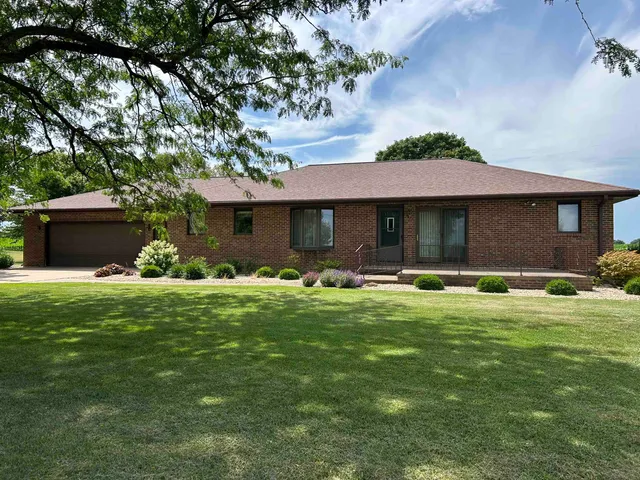 a front view of a house with a garden and porch