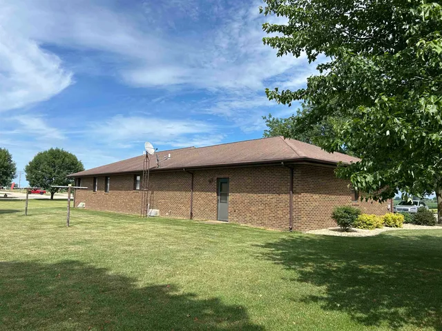 a backyard of a house with table and chairs
