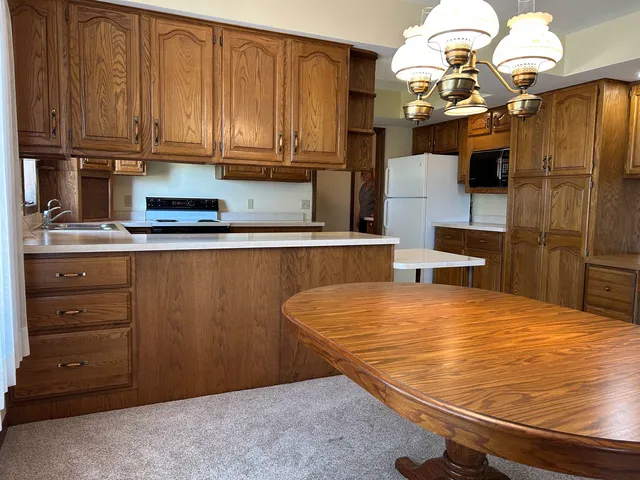 a kitchen with stainless steel appliances wooden cabinets a stove and a refrigerator