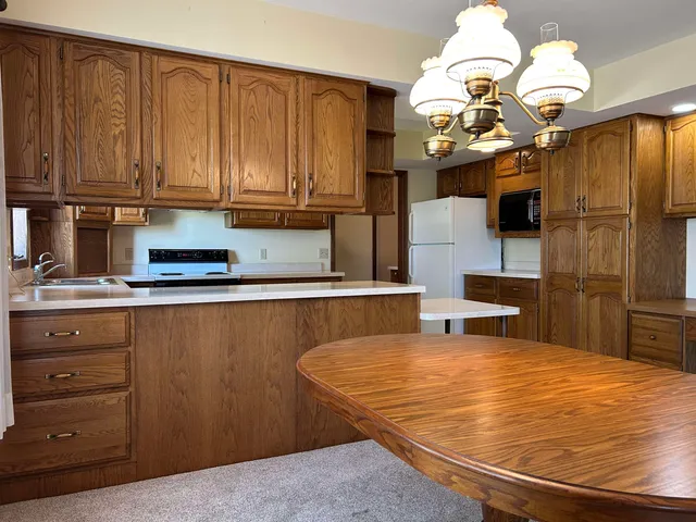 a kitchen with stainless steel appliances granite countertop a sink dishwasher and a microwave oven with cabinets