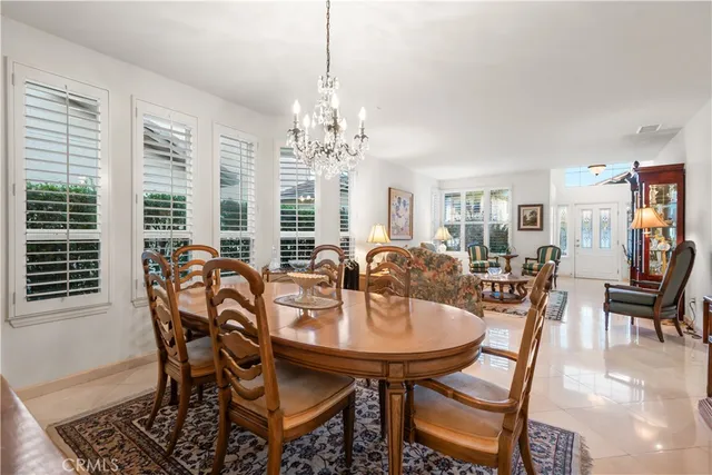 a view of a dining room with furniture and chandelier