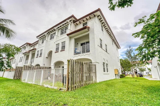 a view of a house with a yard and plants