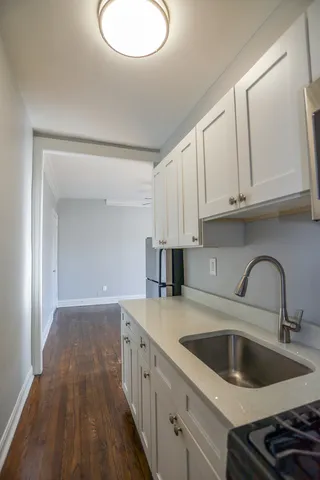 a kitchen with a sink and cabinets