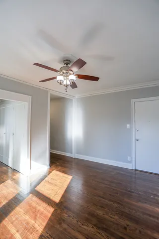 a view of an empty room with wooden floor