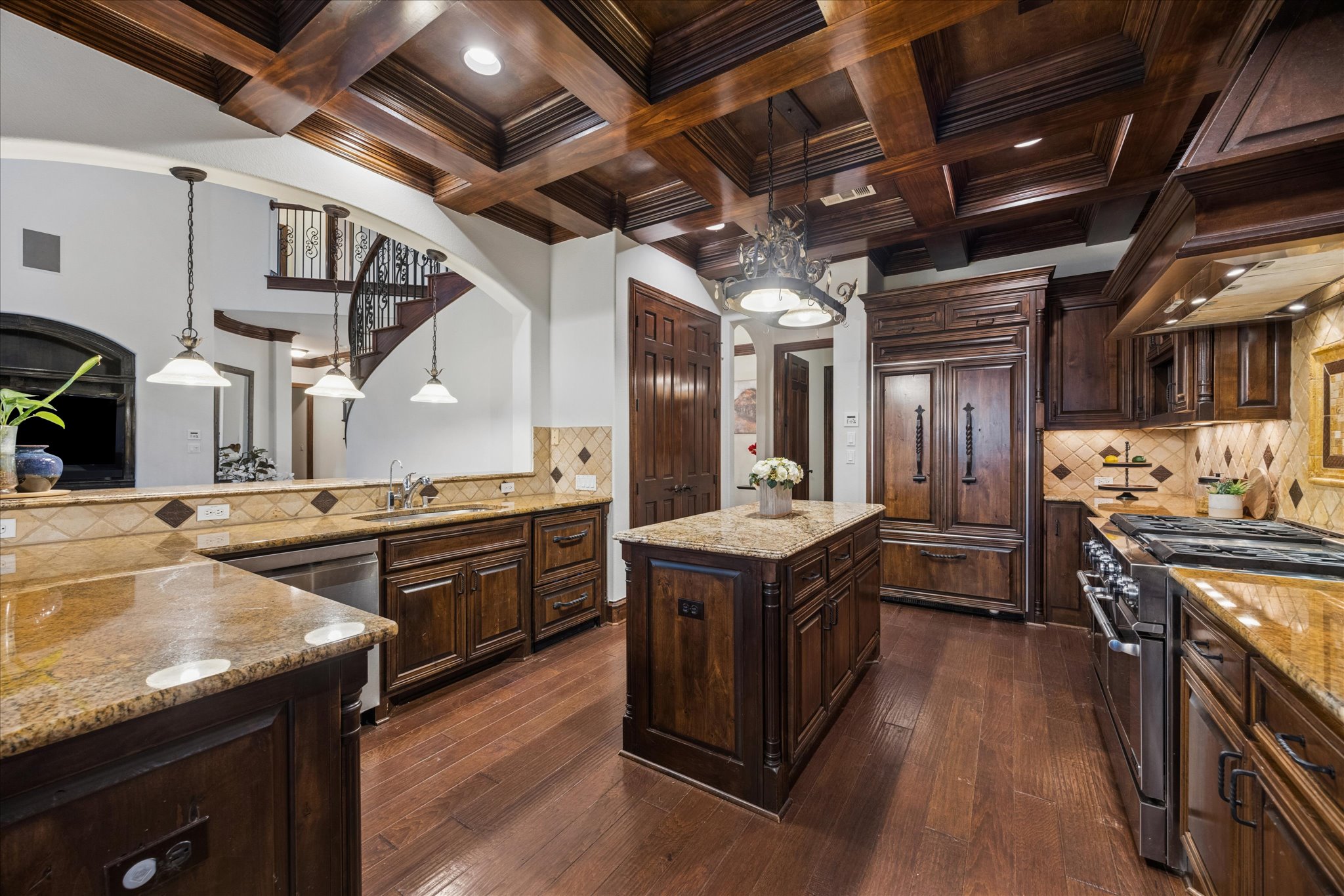 11805 Ranchview Court Austin, TX 78732 - Photo 9 of 36 Gourmet kitchen featuring a coffered wood ceiling, wood-finish flooring, granite countertops, custom wood cabinetry, and stainless steel appliances