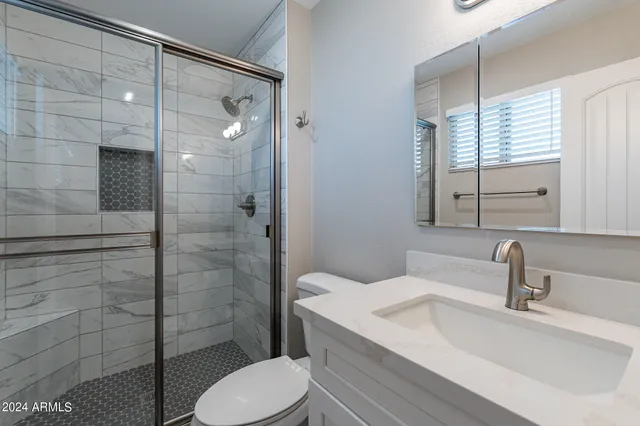 an empty room with a window and a ceiling fan