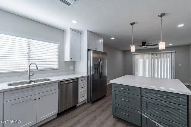 a kitchen with a sink stove and refrigerator