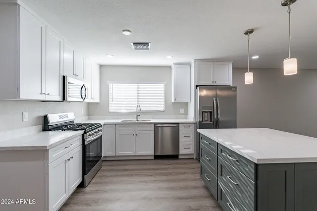 a kitchen with a sink stove and refrigerator