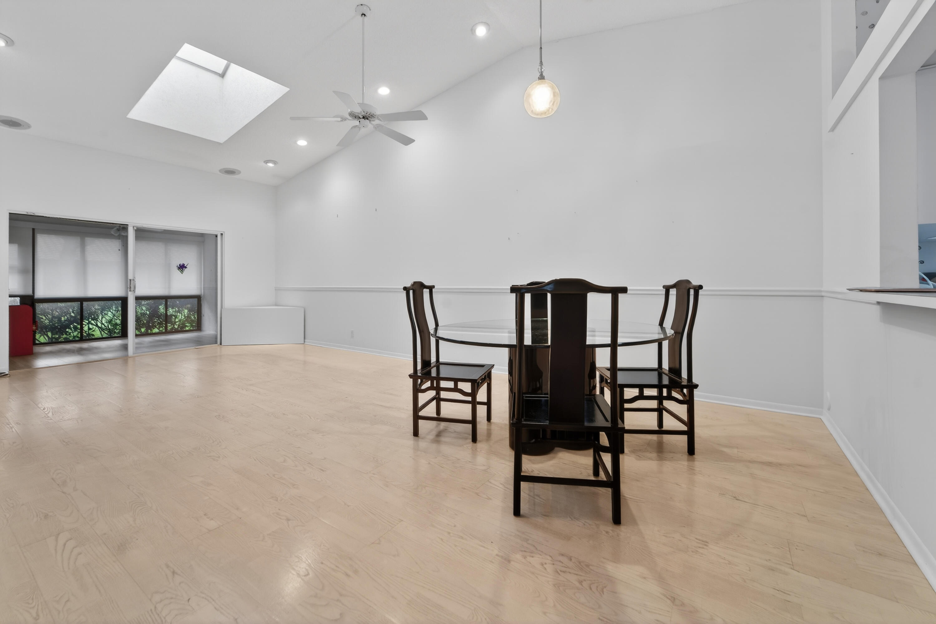 an empty room with furniture and a chandelier
