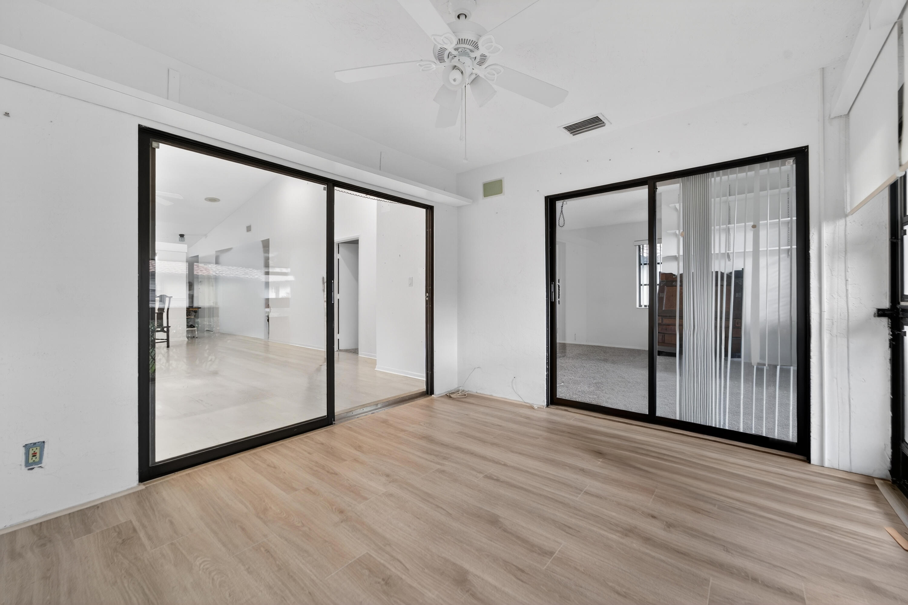 6371 Kings Gate Circle Delray Beach, FL 33484 - Photo 12 of 52 a view of empty room with wooden floor
