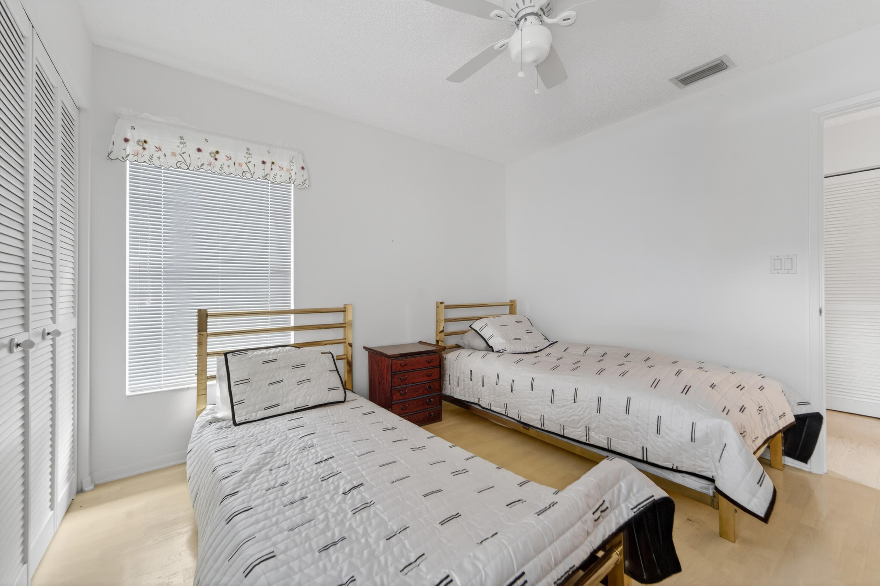 6371 Kings Gate Circle Delray Beach, FL 33484 - Photo 14 of 52 a bedroom with bed and wooden floor